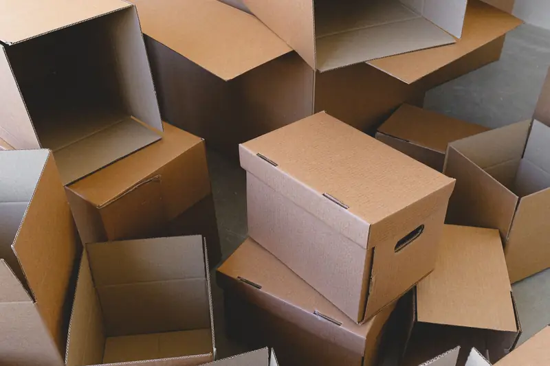 Open cardboard boxes of different sizes prepared for a move.