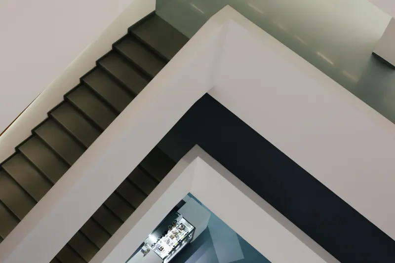 Several flights of stairs connected by landings inside a building.