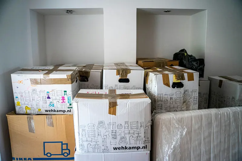 Taped boxes and a wrapped item grouped inside a home.